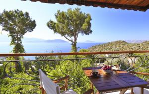 a table and chairs on a balcony with a view of the ocean at Hamarat Otel in Kaş