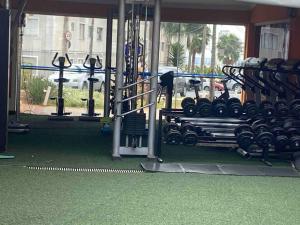 a gym with a bunch of equipment in a room at Novíssimo apartamento térreo in Votorantim