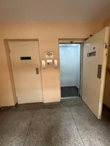 an empty hallway with two elevators in an office building at Apartamento próximo ao metro Jabaquara, apto 47 in São Paulo