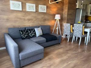 a living room with a couch and a table and chairs at Apartment Stella in Varna City