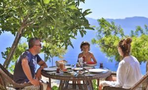 a group of people sitting around a table at Hamarat Otel in Kaş