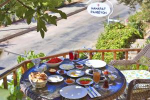 a blue table with food and drinks on it at Hamarat Otel in Kaş