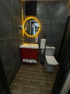 a bathroom with a sink and a toilet and a mirror at Viv City Hotel in Istanbul