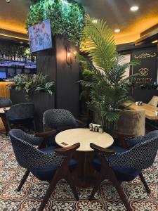 a restaurant with tables and chairs and plants at Viv City Hotel in Istanbul