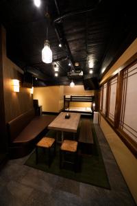a room with a table and chairs and a couch at HOTEL Lee in Tokyo
