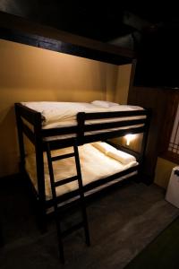 a bunk bed with a ladder in a room at HOTEL Lee in Tokyo