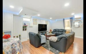 sala de estar con 2 sofás y TV en Splendid Cheerful 2-bedroom residential, en Hyattsville
