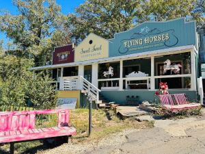 a building with a pink bench in front of it at Acorn Hideaways Canton Sweet Tweet Guesthouse King Bed in Canton