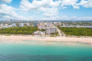 an aerial view of a beach in front of a city at Seaside Escape Steps to Beach, Dining, Shopping and Las Olas! in Fort Lauderdale