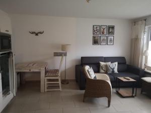 a living room with a blue couch and a table at Ferienwohnung Bergjuwel in Fischen +7 photos
