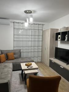 a living room with a couch and a table at NASTIĆ Apartmani in Kragujevac +15 photos