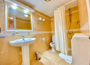 a bathroom with a sink and a toilet and a mirror at Plaza Corniche in La Marsa