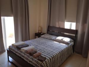 a bedroom with a bed with two towels on it at Xylophagou Larnaca Ayia Napa 1 bedroom apartment in Xylophaghou