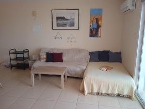 a living room with a couch and a table at Xylophagou Larnaca Ayia Napa 1 bedroom apartment in Xylophaghou