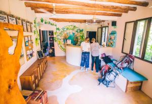 two women standing in a room with a damaged floor at Tribu Hostel in Holbox Island