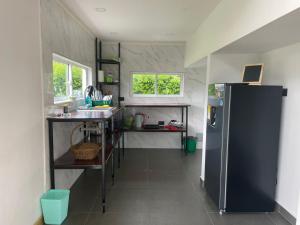 a kitchen with a refrigerator and a counter top at Tiny House Tauramena in Tauramena