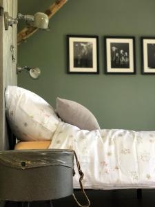 a couch in a living room with pictures on the wall at The Cat and The Owl B&B in Groenlo