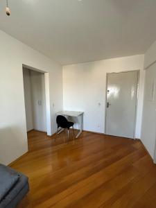 an empty living room with a chair and a desk at Apartamento próximo ao metro Jabaquara, apto 13 in São Paulo