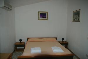 Postel nebo postele na pokoji v ubytování Le Due Lanterne