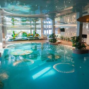 a large blue swimming pool in a building at RING Sport Hostel in Tallinn