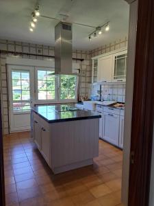 a large kitchen with white cabinets and a large island at Casa Ares in Cee +27 photos