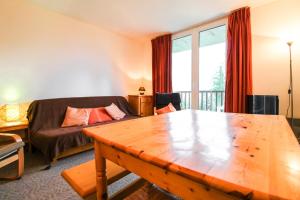 una sala de estar con una mesa y un sofá en Spacious Apartment Iris, Flaine Foret, en Flaine