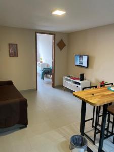 a living room with a couch and a table at Apartamento Copacabana, Vista para o mar e com garagem in Rio de Janeiro
