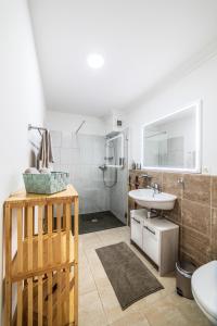 a bathroom with a sink and a toilet and a shower at Loft Savièse in Savièse