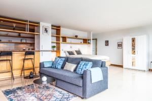 a living room with a couch and a bed at Loft Savièse in Savièse