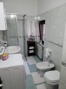 a bathroom with a sink and a toilet and a shower at La Vecchia Riseria 1 in Novara