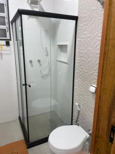 a bathroom with a toilet and a glass shower at Apartamento Copacabana, Vista para o mar e com garagem in Rio de Janeiro +11 photos