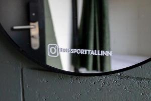 a mirror on the side of a wall at RING Sport Hostel in Tallinn