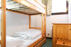 two bunk beds in a room with a window at Spacious Apartment Iris, Flaine Foret in Flaine