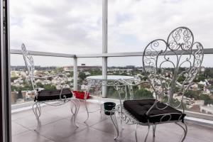 two chairs and a table on a balcony at Libertador 6430 by depptö in Buenos Aires