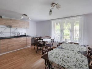 a kitchen and dining room with a table and chairs at Willa Tomek in Krynica Zdrój