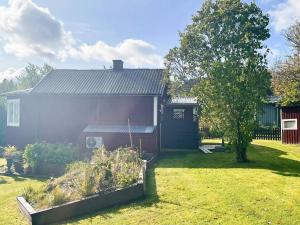 a house with a garden in front of it at Holiday home JÖNKÖPING III in Jönköping