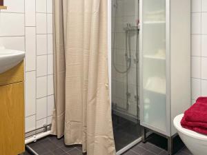 a bathroom with a shower and a toilet and a sink at Holiday home JÖNKÖPING III in Jönköping