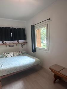 a small bedroom with a bed and a window at Ridge Line in Ponte di Legno