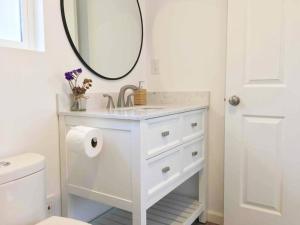 bagno bianco con lavandino e specchio di The Cozy Oasis - A Renovated and Modern Studio near LAX + SoFi + Beaches + Freeway a Lawndale