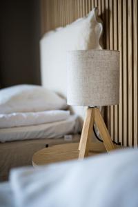 a lamp sitting on a table in a bedroom at Hotell Hertig Karl in Filipstad