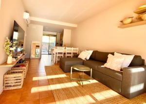 a living room with a couch and a table at Kalma House in Torroella de Montgrí