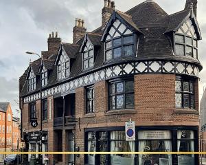a large brick building with a police tape around it at Old Market Apartments in Altrincham
