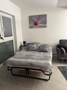 ein Schlafzimmer mit einem Bett mit einem Apfel an der Wand in der Unterkunft ruhig wohnen im kleinen Bungalow im Süden von Berlin in Teltow