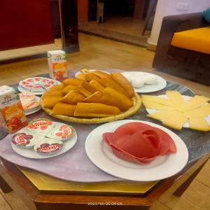 a table with plates of food on a table at The location Hotel in Cairo