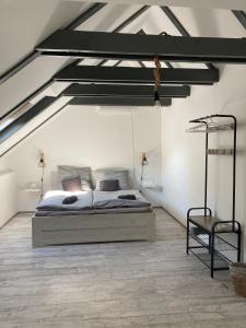 a bedroom with a large bed in a attic at Mezriczky Malom Kapolcs in Kapolcs