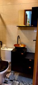 a bathroom with a sink and a toilet at Sobradinho Novo com piscina - Praia do Morro Guarapari ES in Guarapari