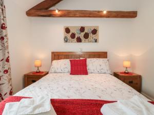 a bedroom with a bed and two lamps on tables at Poppy Cottage in Cowbridge