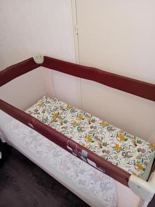 a bed in a room with a mattress with flowers on it at Monte Cristo in Metz