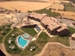 an aerial view of a large house with a swimming pool at Hotel Spa Aguas de los Mallos in Murillo de Gállego