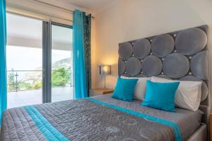 a bedroom with a large bed with a large window at Belo Mar in Arco da Calheta +20 photos